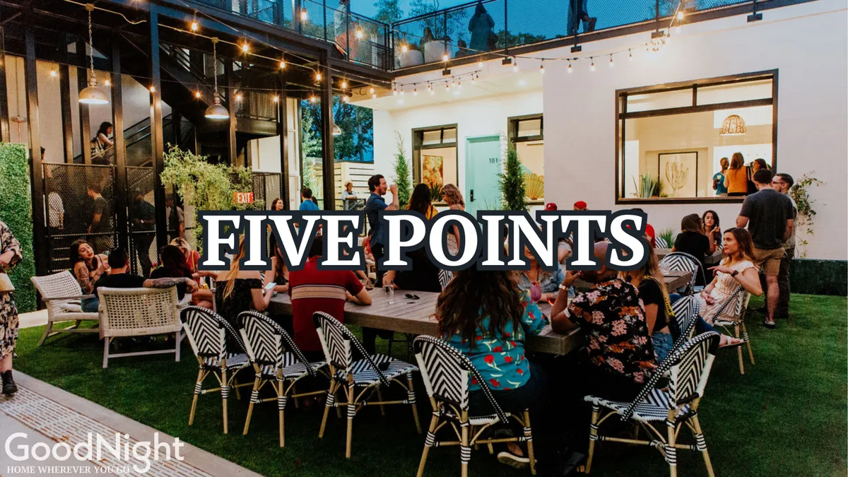 A festive outdoor dining area strung with lights, featuring groups of people celebrating, dining, and socializing. This inviting exterior shows a communal space perfect for gatherings and group outings, echoing the spirit of bachelor/bachelorette parties or friends’ trips.