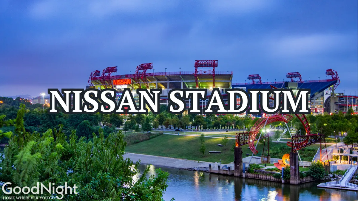 A vibrant exterior shot of Nissan Stadium with the river and a green park area in the foreground. The lively atmosphere showcases the stadium as a hub for concerts and events, while the park and river walkway connect visitors to the city's outdoor spirit.